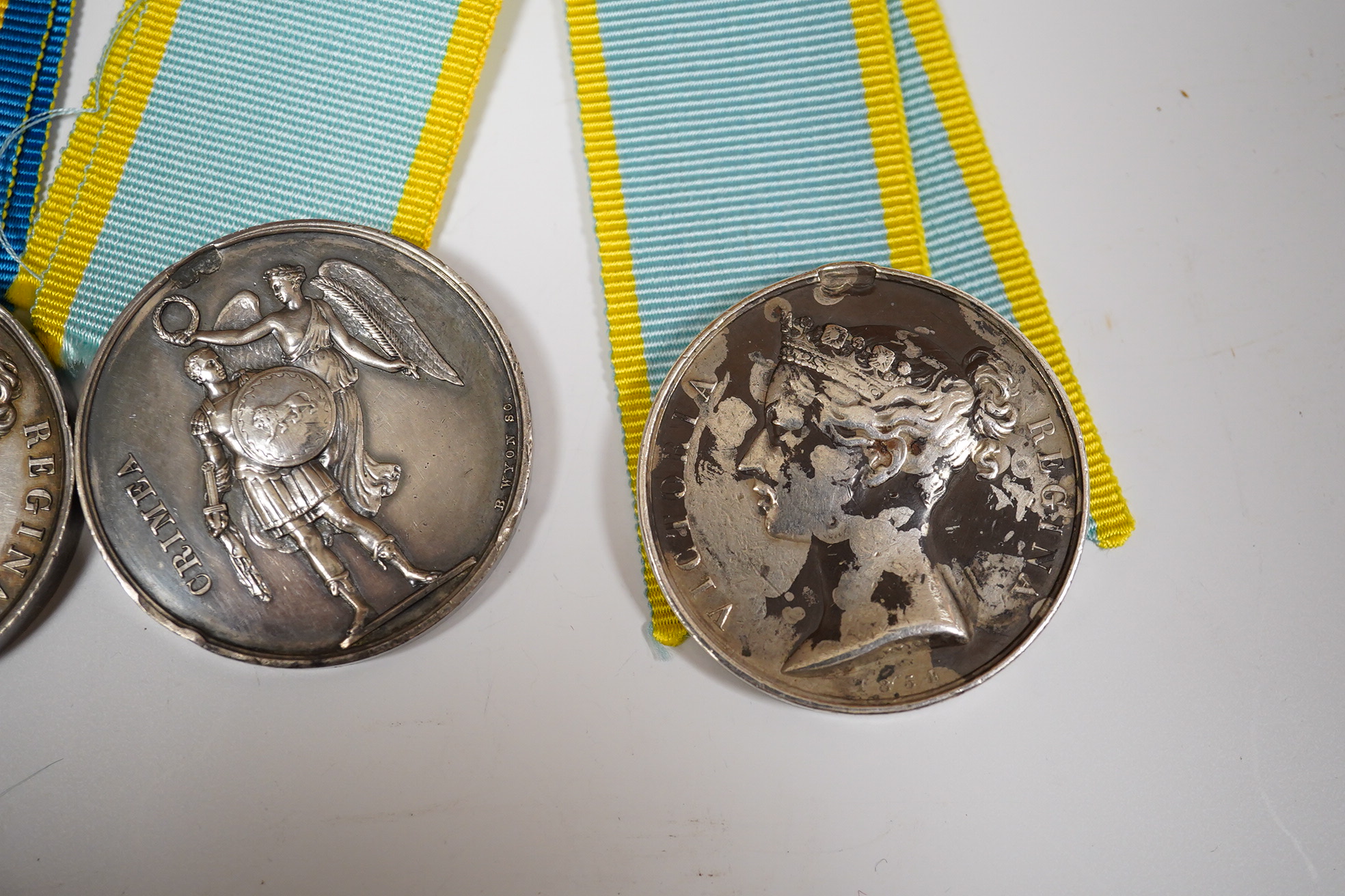 Two Crimea medals, a Baltic medal, all disc only and unnamed with a replica Turkish Crimea medal, unnamed, (3).